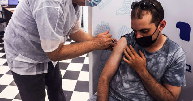 Israel pushes booster shots as Covid cases set new record